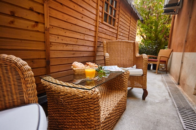 Fresh pastries, orange juice, olive branch and fresh newspaper on the table for breakfast