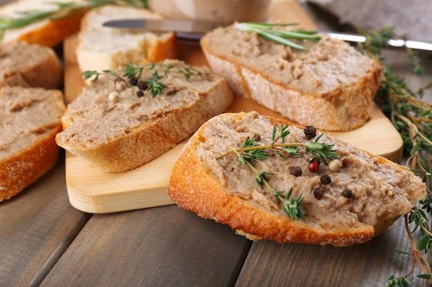 Fresh pate with bread on wooden table