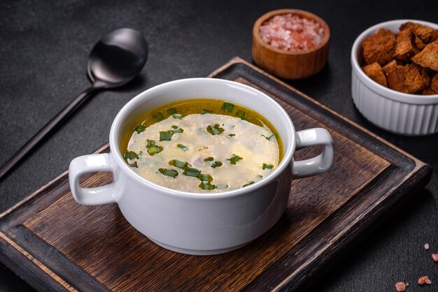 Fresh pea soup in bowl on black background Cooking at home