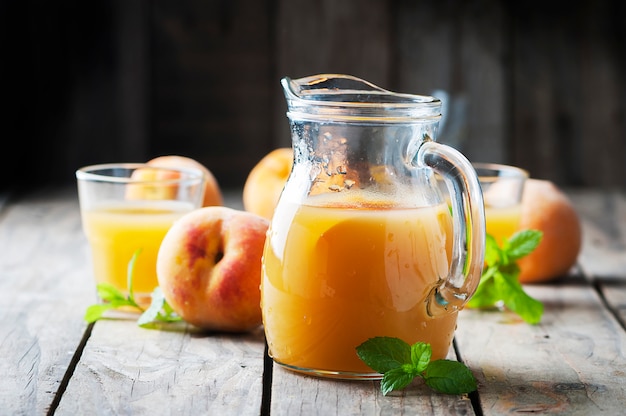 Fresh peach juice with mint on the wooden table