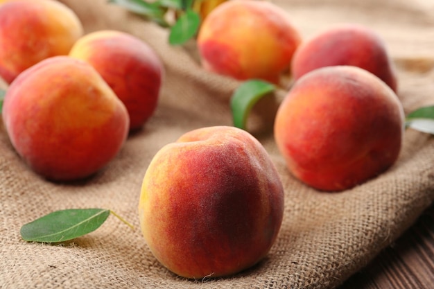 Fresh peaches on sackcloth closeup