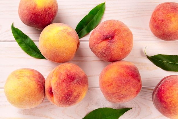 Fresh peaches on a wooden table summer peach fruit background