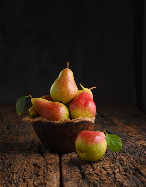 Fresh pear fruits on wooden bowl