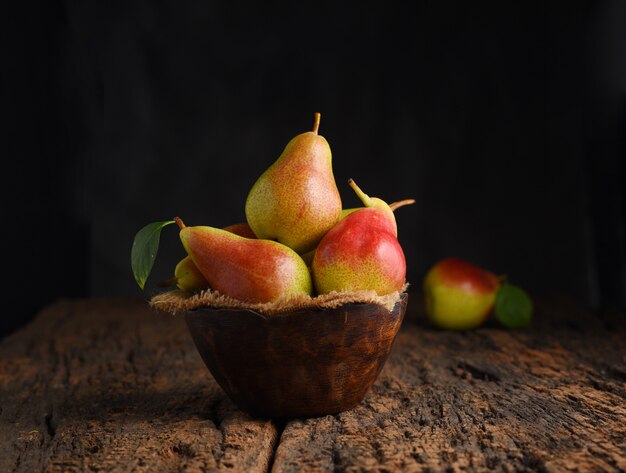 Fresh pear fruits on wooden bowl