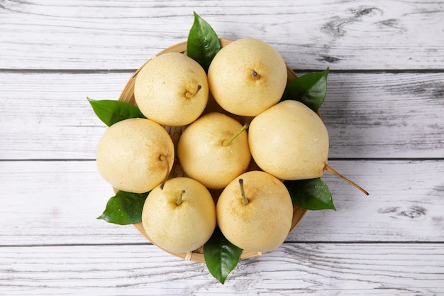 Fresh pear isolated above wooden table