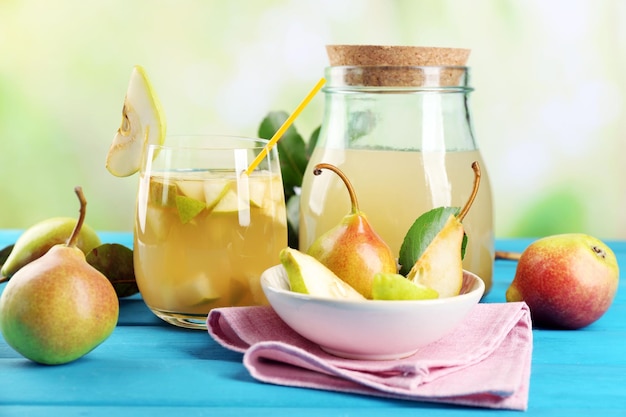 Fresh pear juice with fruit on bright background