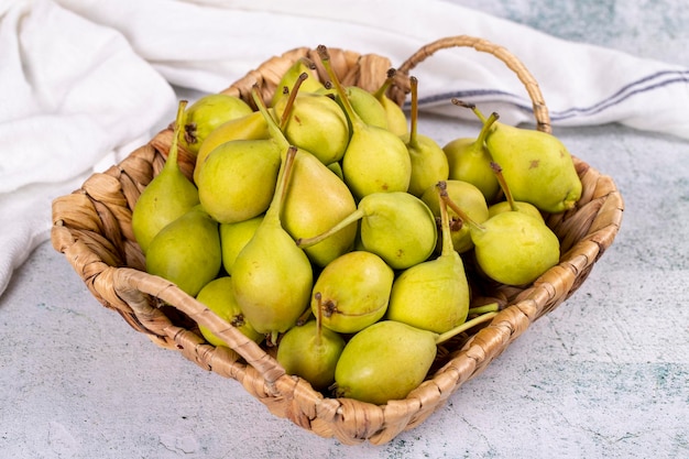 Fresh pear Ripe pears in a basket on a stone background Bulk pear close up