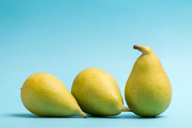 Fresh pears on blue background