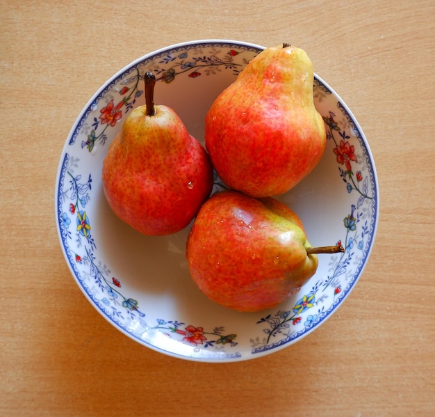 Fresh pears in a white plate on the table