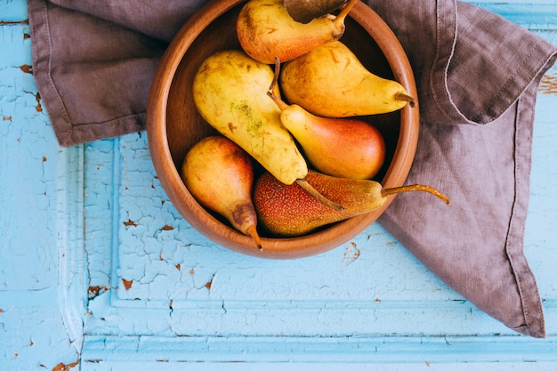 Fresh pears in a wooden plate