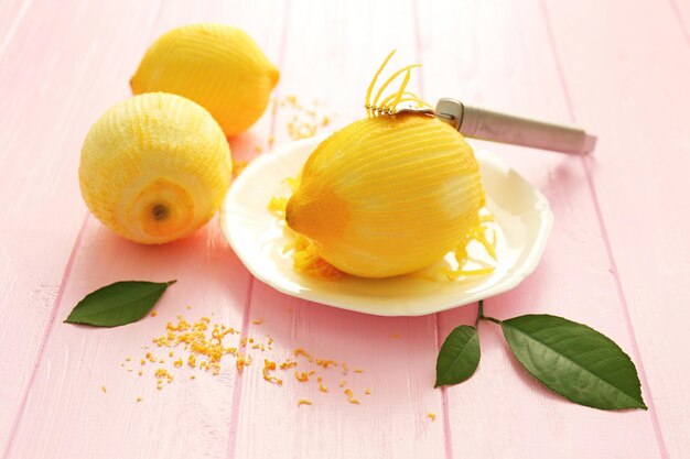 Fresh peeled lemons and zest on wooden table