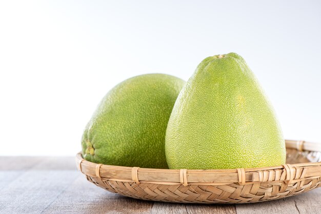 Fresh and peeled pomelo(shaddock), grapefruit with slices on wooden table background