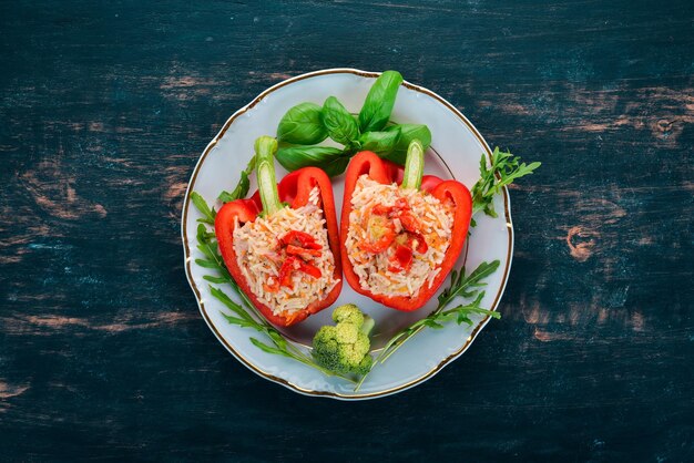 Fresh pepper stuffed with rice and meat On a wooden background Top view Copy space