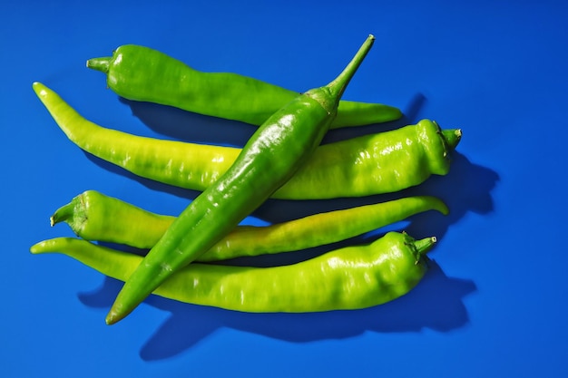 Fresh peppers on blue background