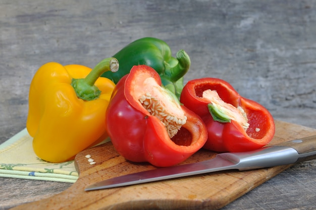 Fresh peppers on wooden plank 