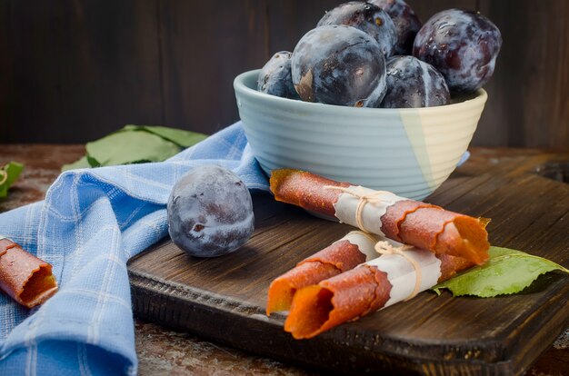 Fresh picked plums in pottery bowl  and plums pastille 