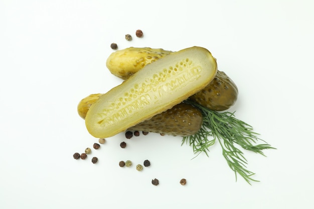 Fresh pickles and spices on white background