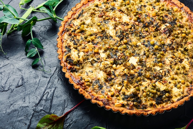 Fresh pie with chard, feta cheese and green peas. Pie with herbs, proper nutrition.