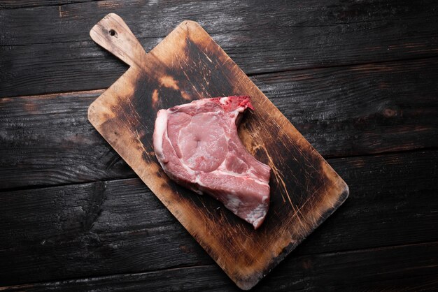 fresh piece of pork lies on a cutting board. Raw piece of meat, ingredient for dinner.