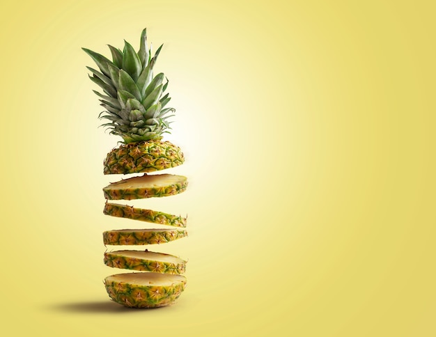 Fresh pineapple cut into slices flying, isolated