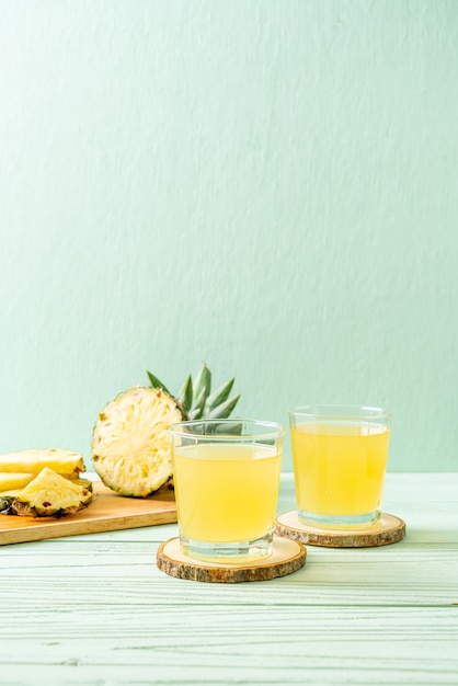 fresh pineapple juice on wood background