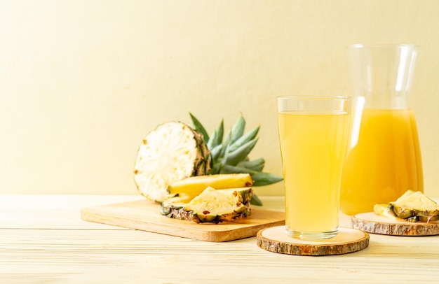 fresh pineapple juice on wood background