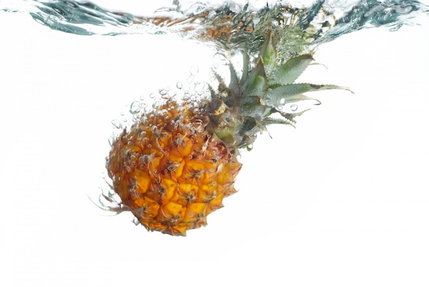 Fresh pineapple jumping into water