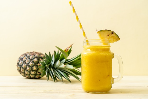 fresh pineapple smoothie glass on wood table