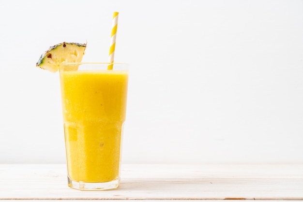 fresh pineapple smoothie glass on wood table