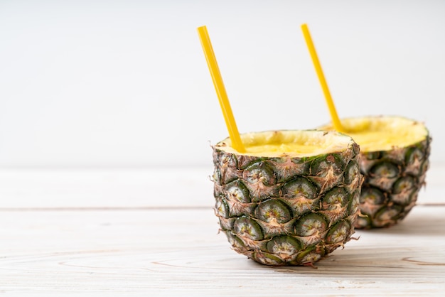 fresh pineapple smoothie glass on wood table
