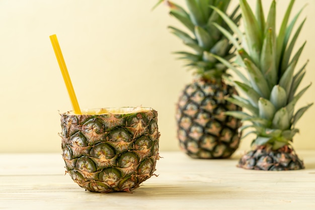 fresh pineapple smoothie glass on wood table