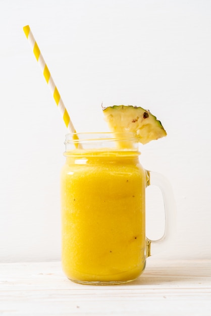 fresh pineapple smoothie glass on wood table