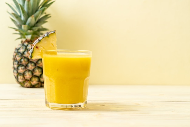 fresh pineapple smoothie glass on wood table