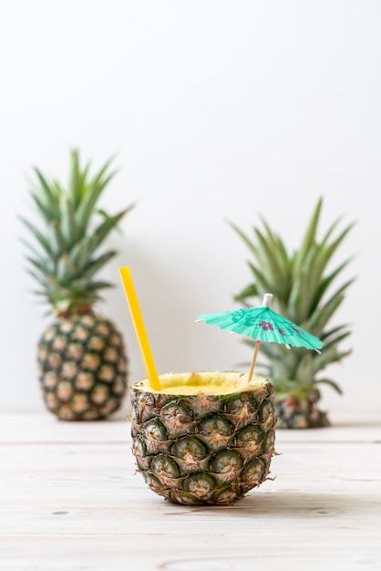 fresh pineapple smoothie glass on wood table