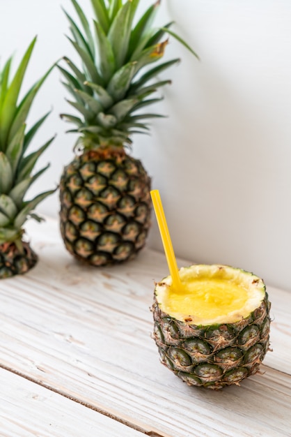 fresh pineapple smoothie glass on wood table
