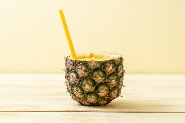 fresh pineapple smoothie glass on wood table