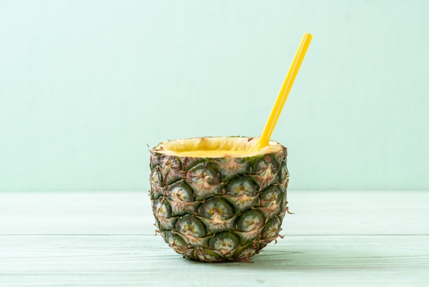 fresh pineapple smoothie glass on wood table