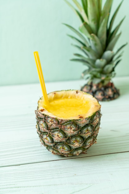 fresh pineapple smoothie on wooden table