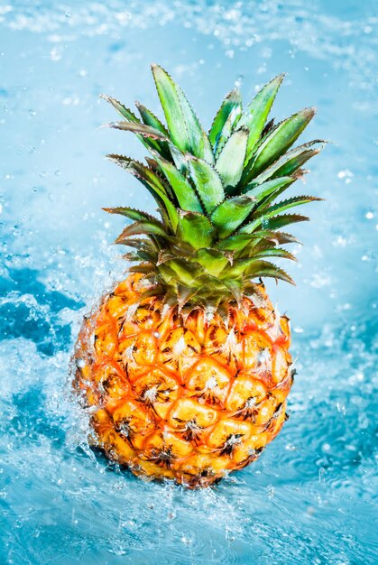 Fresh pineapple in water splashes