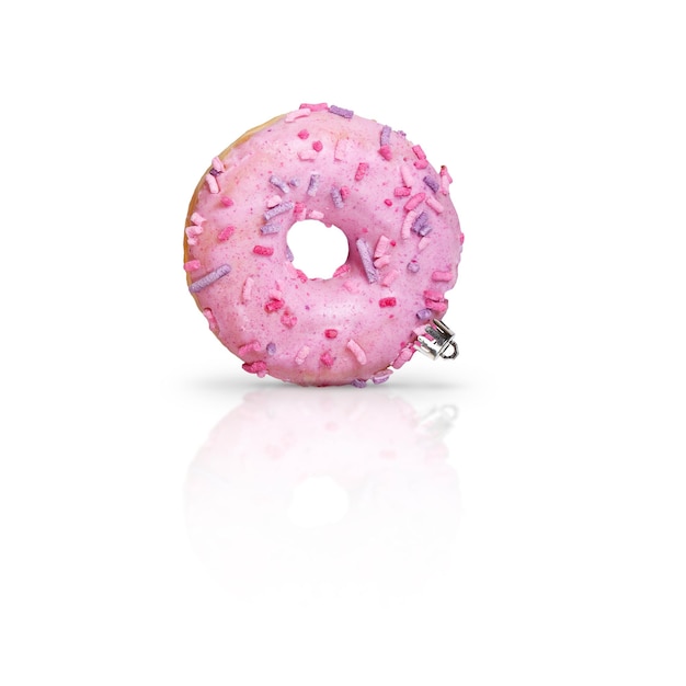 Fresh pink glazed donut as Christmas decorations on white background with reflection