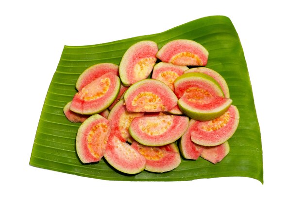 Fresh pink guava on banana leaf background.