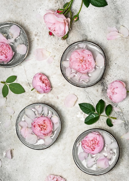 Fresh pink roses and rose petals in the bowls of fragrant water