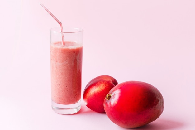 Fresh pink smoothie with peach and mango