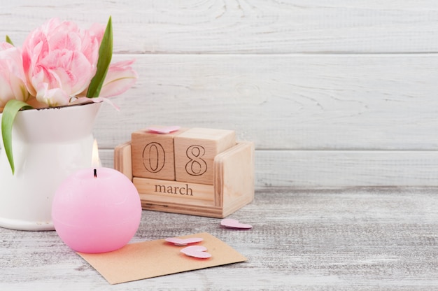 Fresh pink tulip flowers and candle