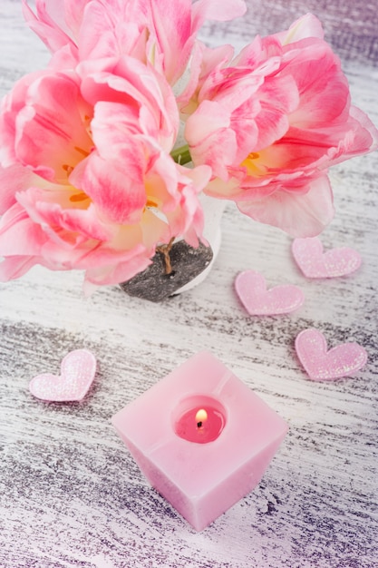 Fresh pink tulip flowers and candle