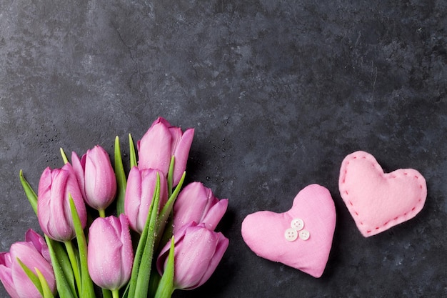 Fresh pink tulip flowers and hearts