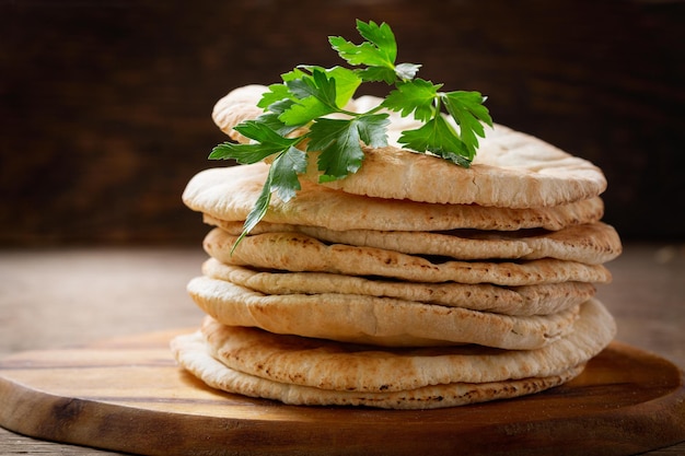 Fresh pita bread on a wooden background