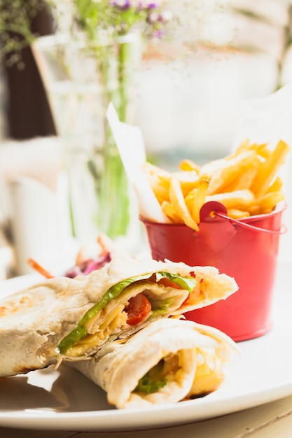 Fresh pita sandwich with French fries and salad