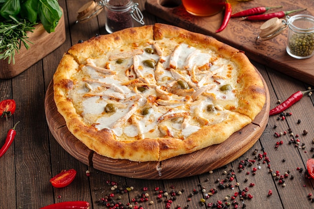 Fresh pizza with chicken and sour cream sauce