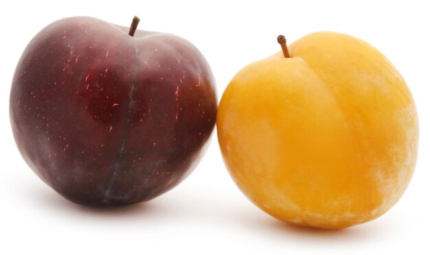 Fresh plums over white background